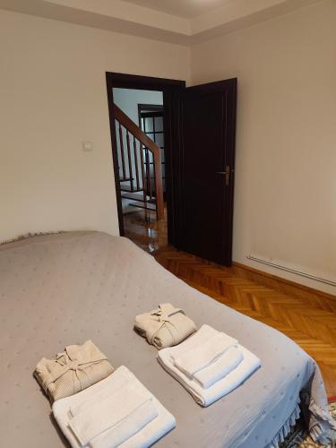 a bedroom with a bed with two towels on it at Casa Paul in Craiova