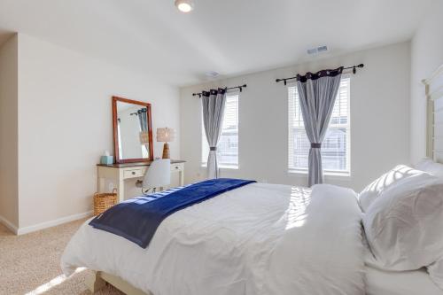 a bedroom with a large white bed and windows at 3 Mi to Bethany Beach The Chiefs Quarters Home in Ocean View