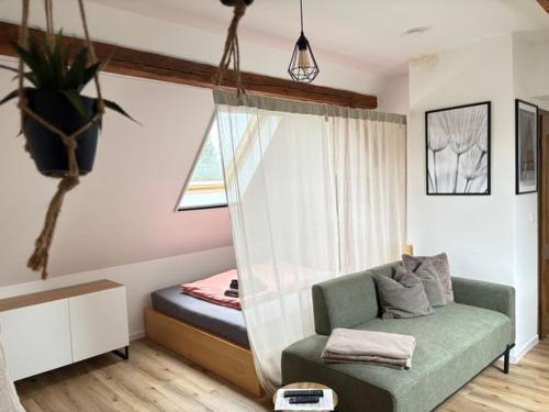 a living room with a couch and a window at Ferienwohnung Willi II in Spremberg