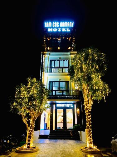 a building with two trees in front of it at Tam Coc Armany Hotel & Sky Restaurant in Vũ Lâm