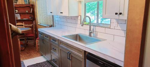 a kitchen counter with a sink and a window at Lakeview Lodge, bookable boat slip! in Bass Lake
