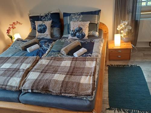 a bed with a blue comforter and pillows at Podhradí 24 in Jáchymov