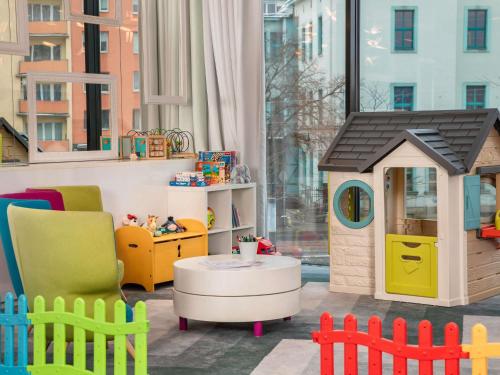 a play room with a toy house and a table at Ibis Styles Wroclaw Centrum in Wrocław