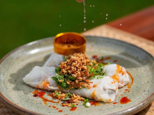 Un plato de comida con algo de comida encima en 3 Nagas Hotel Luang Prabang - MGallery Collection, en Luang Prabang
