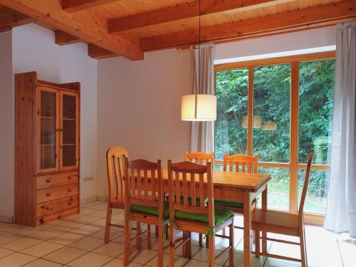 a dining room with a wooden table and chairs at Natur Ferienpark 9 - Typ C in Nieheim