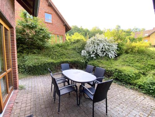 a table and chairs on a brick patio at Haus 2 Naturerlebnisse und Erholung im Natur Ferienpark in Nieheim