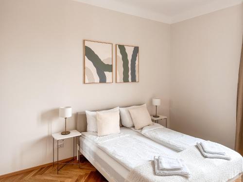 Un dormitorio blanco con una cama y dos lámparas. en Radiant Apartment near Milano, en Sesto San Giovanni