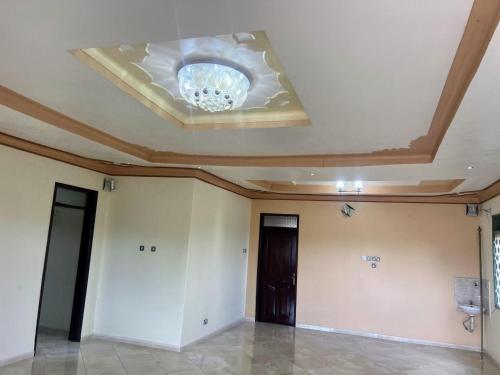 a room with a ceiling with a chandelier at Antique Family Residence in Kitala