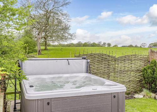 a hot tub in a yard with a field at Ladera Retreat Lodges in Eaton
