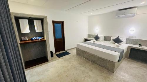 a bedroom with a large bed and a sink at Royal Sea Wind in Matara