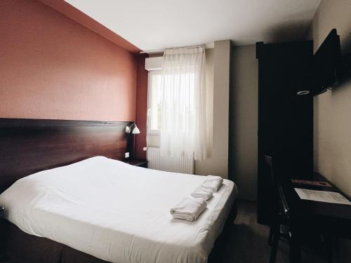 LimasにあるLogis Hôtel Novaの白いシーツと窓のあるベッドのある寝室