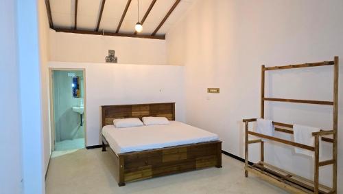 a bedroom with a bed and a bathroom at Canmin Guest House in Galle
