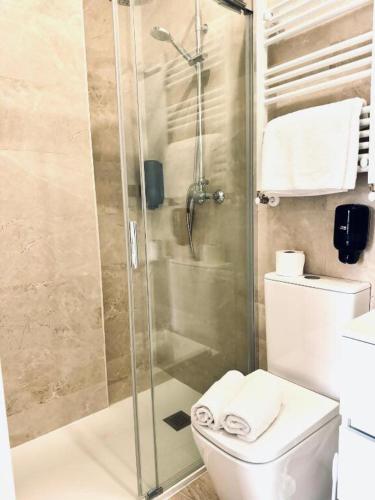 a bathroom with a shower and a toilet at Santander suites and rooms atlántico in Santander