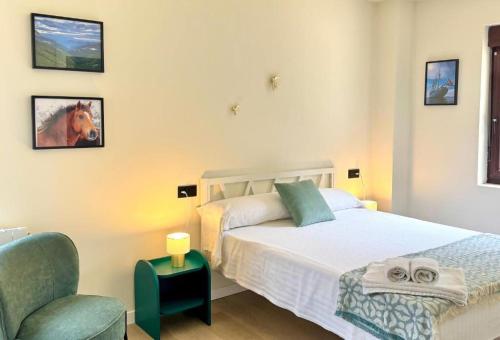 a bedroom with a bed and a chair at Santander suites and rooms atlántico in Santander