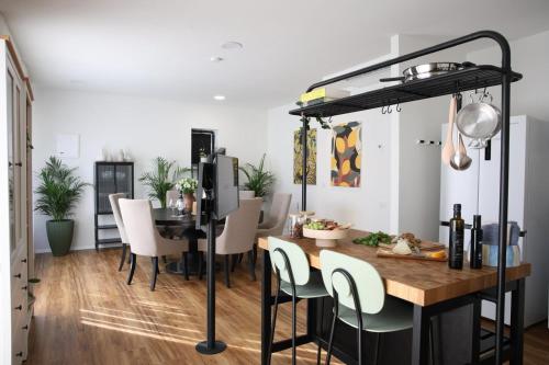 a dining room with a table and a loft bed at וילה מעגל השמש in Poriyya Illit