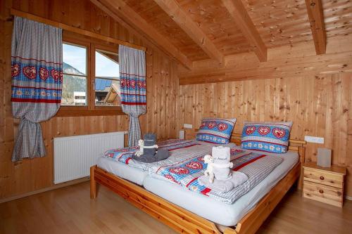 a bedroom with a bed in a log cabin at Chalet Auszeit Montafon in Bartholomäberg