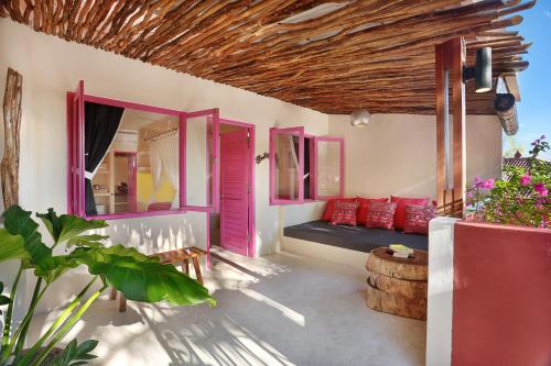 
a room with a pink wall and a blue wall at PinkCoco Uluwatu - Cool Adults Only in Uluwatu
