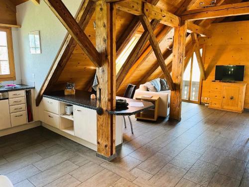 a kitchen and living room in a wooden cabin at Haus Itten in Hondrich