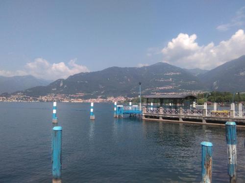 a dock on a lake with mountains in the background at Casa Poni in Pisogne