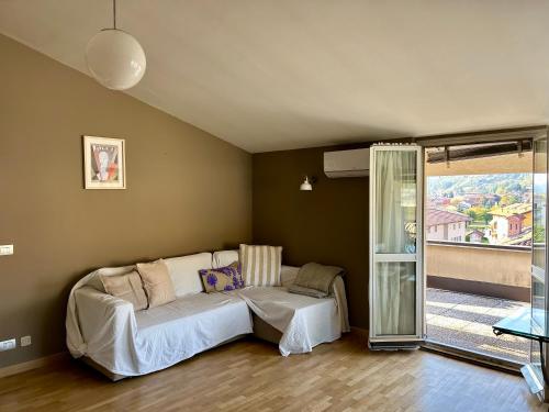 a living room with a couch and a sliding glass door at La Terrazza in Piobesi dʼAlba