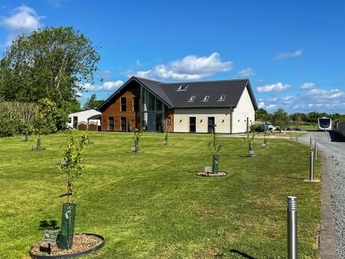 a house with a bunch of trees in the yard at The Paddocks Retreat in North Thoresby
