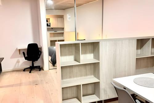 an office with white cabinets and a desk and a chair at Uriarte Suites in Buenos Aires