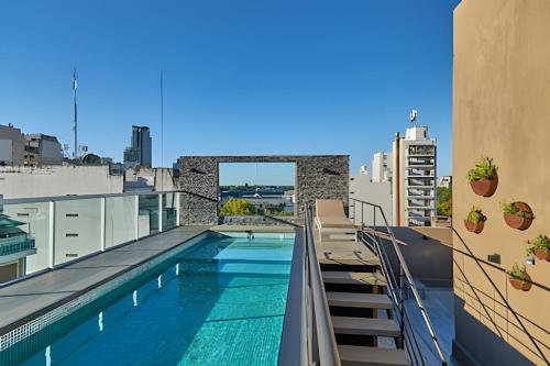 a swimming pool on the roof of a building at Uriarte Suites in Buenos Aires