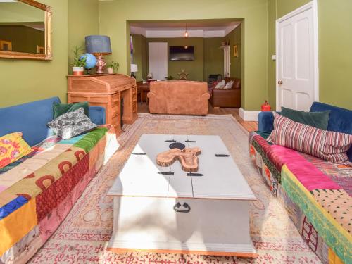 a living room with two couches and a table at Sunnycote in Arnside