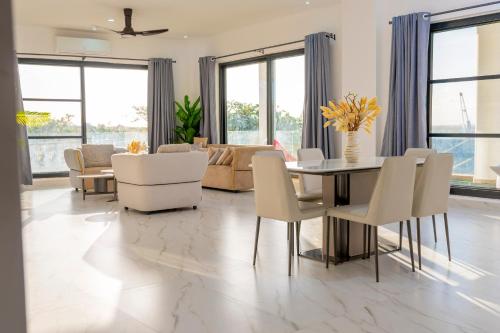 a living room with a table and chairs at Sweet Apartment in Tanga