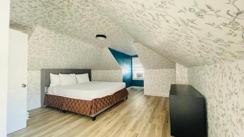a bedroom with a bed in a attic at Vibes Villa in Wildwood