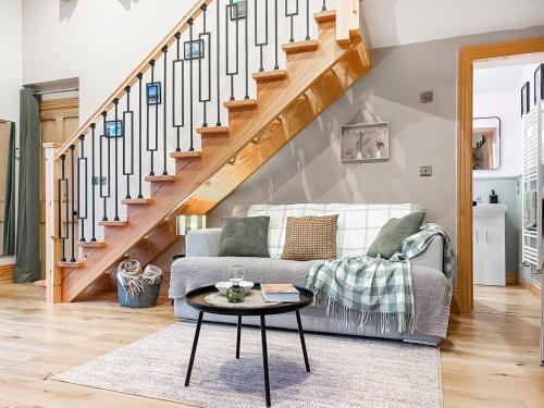 a living room with a couch and a table at The Coal House in Skipton