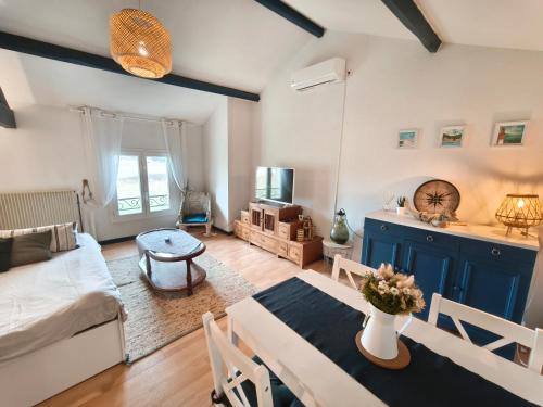 a living room with a couch and a table at La Bastide Girondine in Saint-Loubès