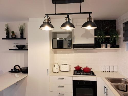 a kitchen with a stove top oven next to a microwave at Naledi Holiday Apartment in Durban