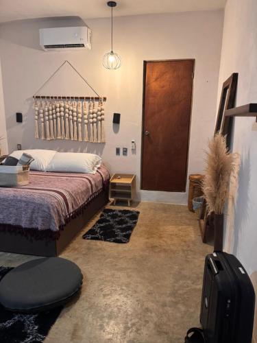 a bedroom with a bed and a brown door at Chii Lú Casa de la Luna in Brisas de Zicatela