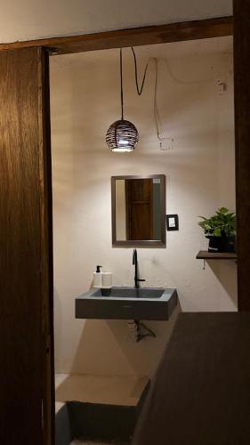 a bathroom with a sink and a mirror at Chii Lú Casa de la Luna in Brisas de Zicatela