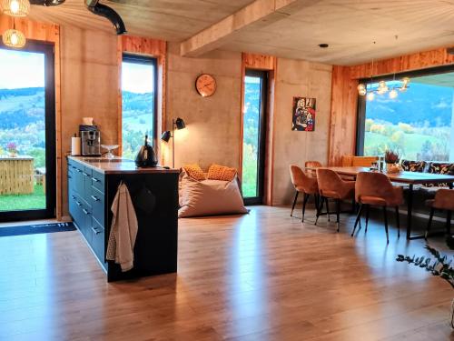 a kitchen and dining room with a table and chairs at Výhledovka chalet in Rokytnice nad Jizerou