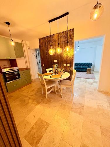 a kitchen and dining room with a table and chairs at Ultracentral 1 Craiova in Craiova