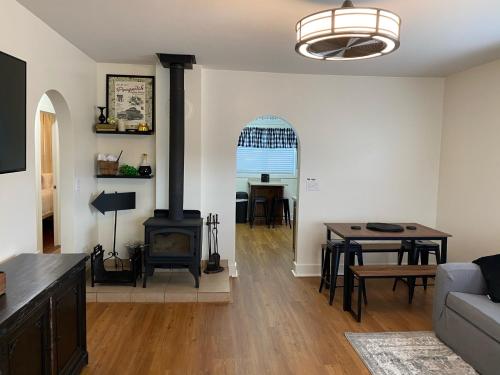a living room with a wood stove and a table at POEs Place in Panguitch
