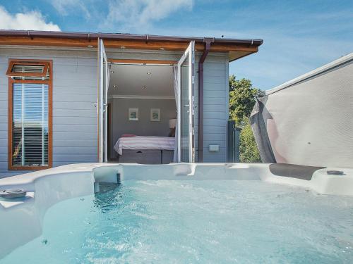a swimming pool in front of a house at 36 At The Sanctuary - Uk50278 in Carnguwch