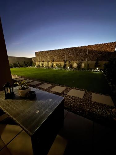 a patio with a table and a field of grass at Apartman Nitra in Nitra