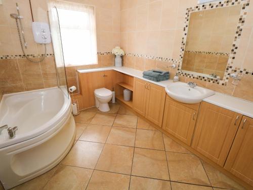 a bathroom with a sink and a toilet and a shower at Carrowreagh in Aclare