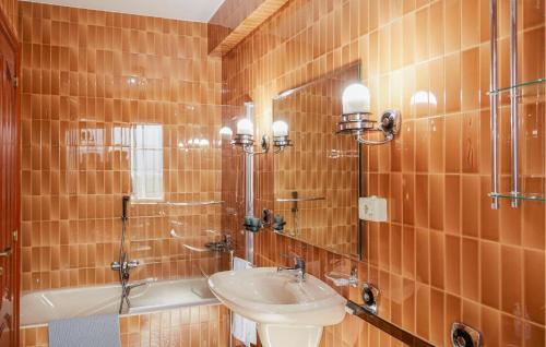 a bathroom with a sink and a toilet and a tub at Villa Rosa Luxury Singular in Padrón