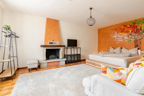 a living room with a bed and a fireplace at Puravida 4seasons - Nature Hideaway in Arveaco