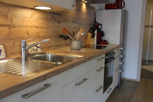 a kitchen with a sink and a refrigerator at Haus Beilerstädtle in Oppenau