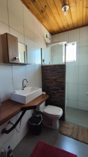 a bathroom with a sink and a toilet at Chalé do Alemão in Imbituba