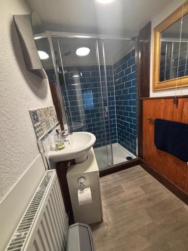 a bathroom with a sink and a shower at Harbour View Ground Floor Flat with Private Parking, only 5 Mins walk to harbour in Brixham