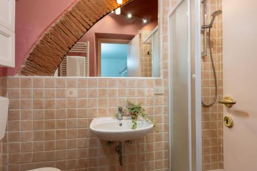 a bathroom with a sink and a mirror at Villa Aurea - Private Pool & Garden in Tuscany in Canneto