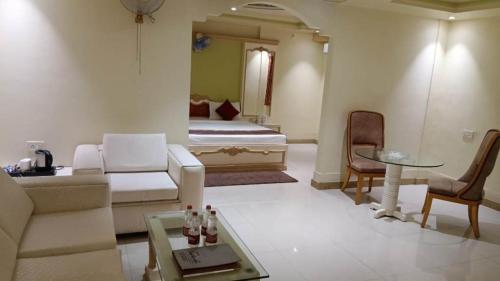 a living room with a couch and a bed at HOTEL SAPTARSHI in Bānkura
