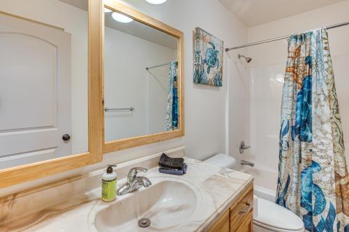 a bathroom with a sink and a toilet and a mirror at Near Dinosaur Natl Monument! High Desert Hideaway in Naples