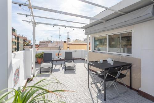a patio with a table and chairs on a balcony at Seaview Apartment N12 in El Perelló